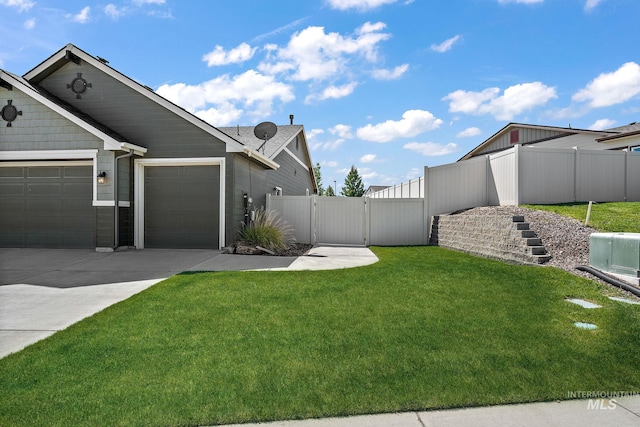 11153 W Brett Dr, Nampa, ID 83686 - view of yard featuring a gate, an attached garage, and driveway
