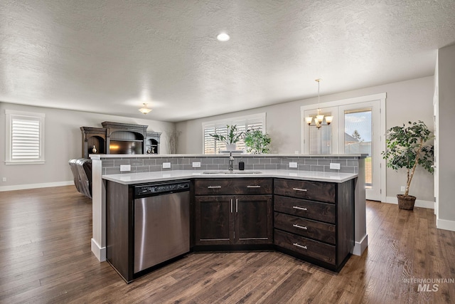 11153 W Brett Dr, Nampa, ID 83686 - kitchen with stainless steel dishwasher, a sink, light countertops, dark brown cabinetry, and baseboards