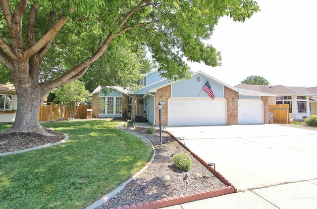 view of front of home with a garage and a front lawn