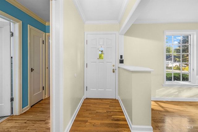 doorway to outside with wood finished floors, baseboards, and ornamental molding