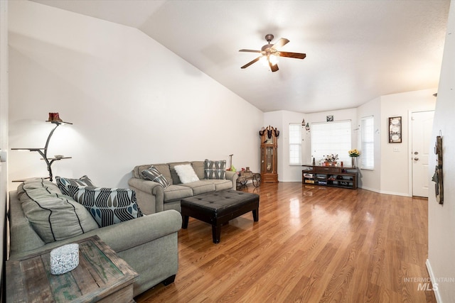 living room with lofted ceiling, light hardwood / wood-style floors, and ceiling fan