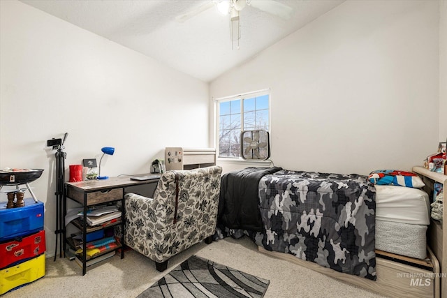 carpeted bedroom with ceiling fan and vaulted ceiling