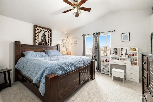 carpeted bedroom featuring vaulted ceiling and ceiling fan