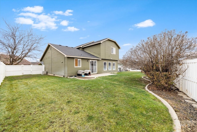 back of house with a patio area and a lawn