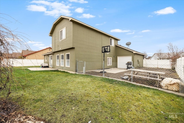 back of house featuring a garage, a patio, and a yard