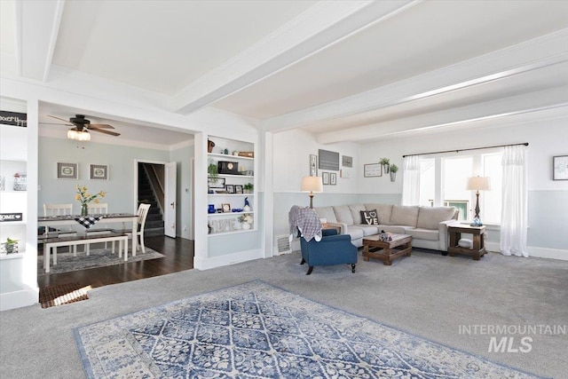 201 9th Ave N, Buhl, ID 83316 - carpeted living room with beam ceiling, a ceiling fan, built in shelves, and baseboards