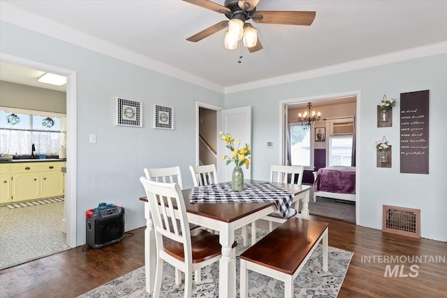 201 9th Ave N, Buhl, ID 83316 - dining area with healthy amount of natural light, wood finished floors, a chandelier, a ceiling fan, and crown molding