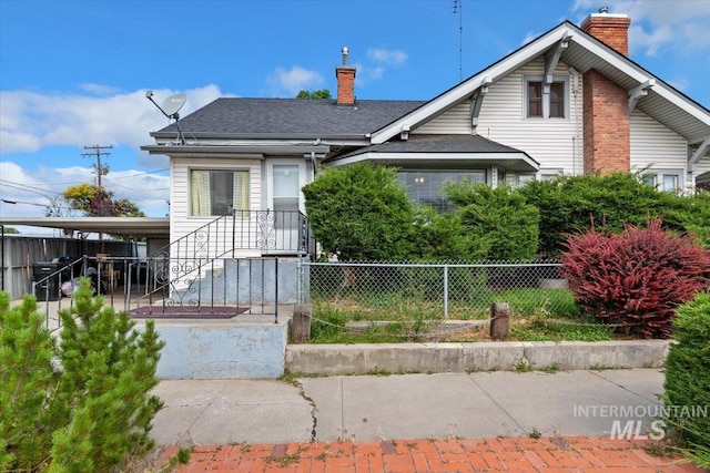 201 9th Ave N, Buhl, ID 83316 - view of front of property featuring a chimney, a fenced front yard, and roof with shingles