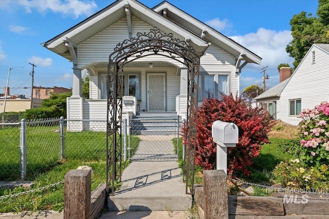201 9th Ave N, Buhl, ID 83316 - shotgun-style home with a gate, covered porch, and a fenced front yard
