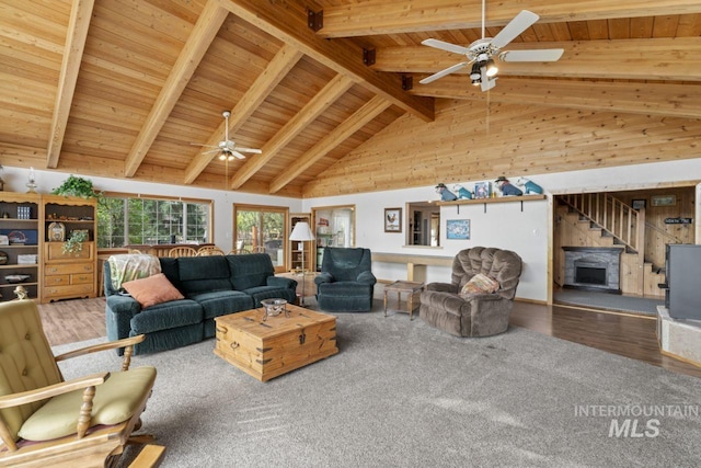 living room with wood finished floors, beamed ceiling, ceiling fan, high vaulted ceiling, and wooden ceiling