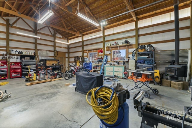 garage featuring a wood stove and a workshop area