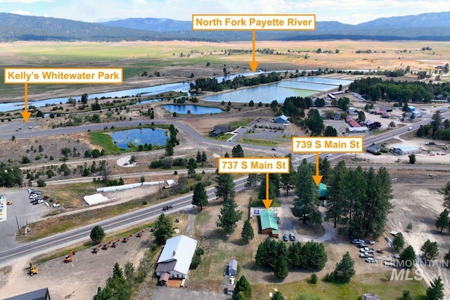 birds eye view of property featuring a water and mountain view