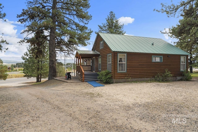view of home's exterior featuring driveway and metal roof