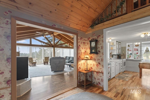interior space with wallpapered walls, wooden ceiling, light wood finished floors, and lofted ceiling