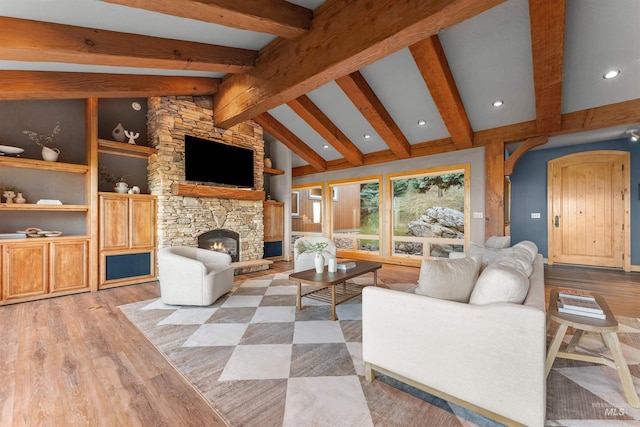 living room with a fireplace, built in features, light wood-type flooring, and lofted ceiling with beams