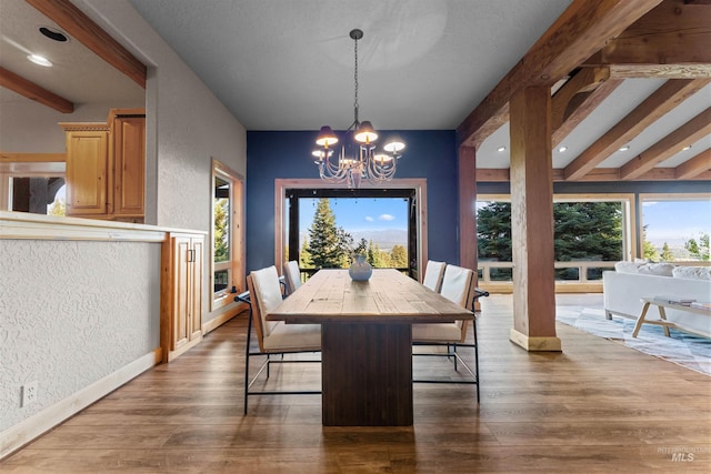 dining space featuring a notable chandelier, beam ceiling, and dark hardwood / wood-style flooring