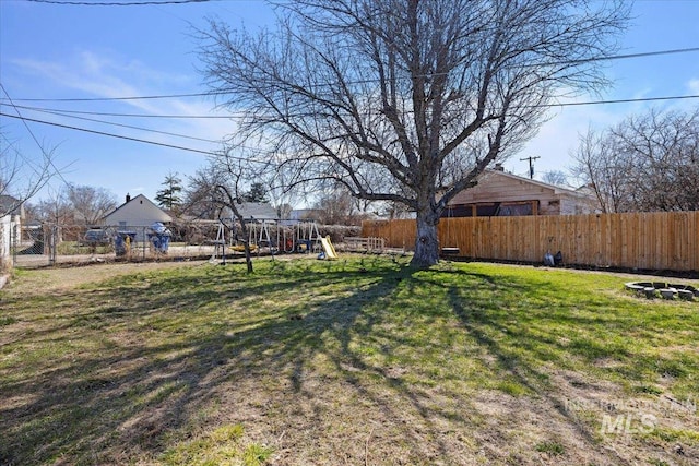 view of yard featuring fence and a playground