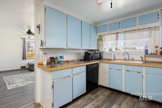 kitchen with black dishwasher, a sink, blue cabinets, and ceiling fan