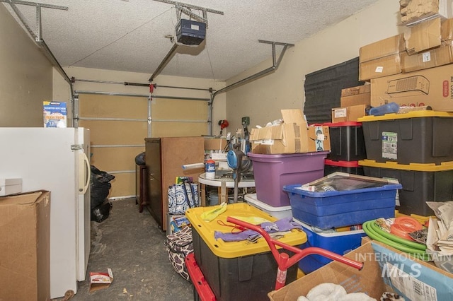 garage featuring a garage door opener and white fridge