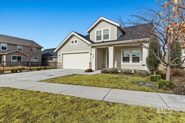 view of front of home with driveway, fence, and a front yard