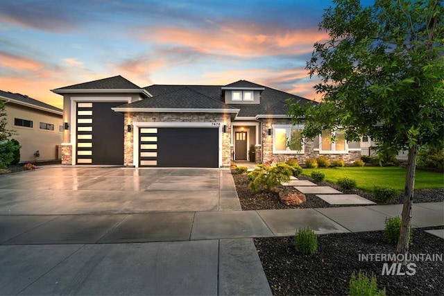 7478 W Palamas, Eagle, ID 83616 - prairie-style house with stone siding, an attached garage, concrete driveway, a lawn, and a shingled roof