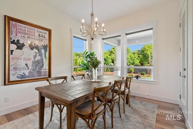 7478 W Palamas, Eagle, ID 83616 - dining room featuring healthy amount of natural light, a chandelier, baseboards, and light wood-style flooring