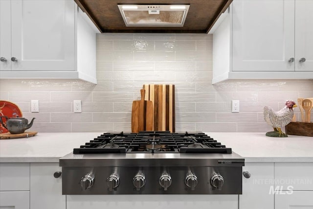 7478 W Palamas, Eagle, ID 83616 - kitchen with stainless steel gas stovetop, white cabinetry, light countertops, and tasteful backsplash