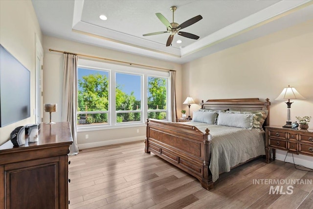 7478 W Palamas, Eagle, ID 83616 - bedroom featuring light wood-style flooring, baseboards, a tray ceiling, recessed lighting, and ceiling fan