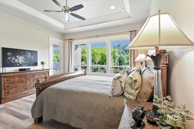7478 W Palamas, Eagle, ID 83616 - bedroom featuring wood finished floors, a tray ceiling, ceiling fan, recessed lighting, and access to outside