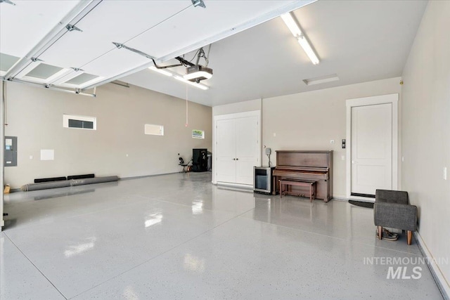 7478 W Palamas, Eagle, ID 83616 - garage with a garage door opener, electric panel, and baseboards