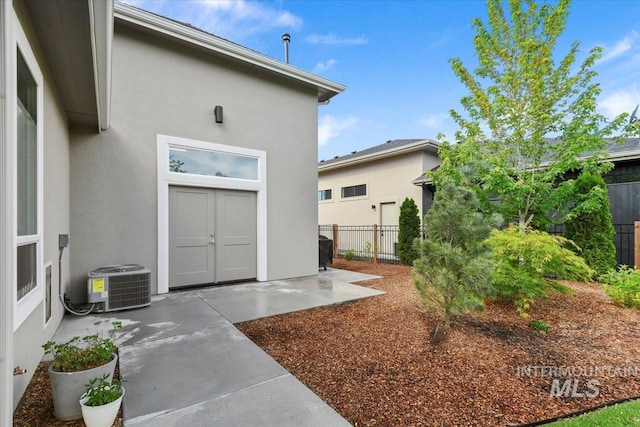 7478 W Palamas, Eagle, ID 83616 - entrance to property with central AC, stucco siding, and a patio