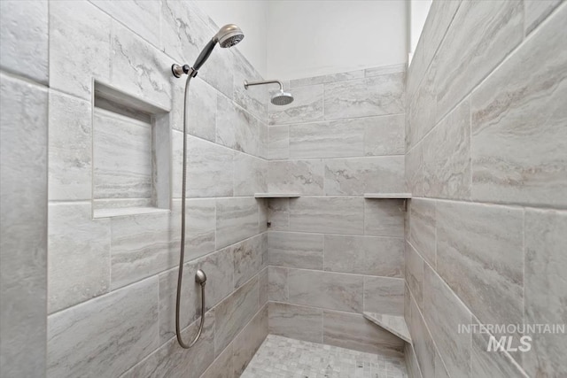 bathroom with tiled shower