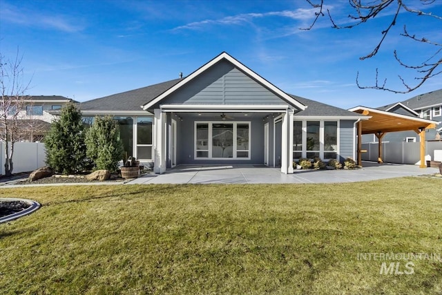 back of property with a patio area, fence, and a yard