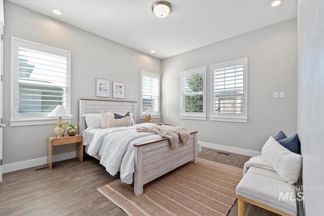 bedroom with recessed lighting, light wood-style flooring, and baseboards