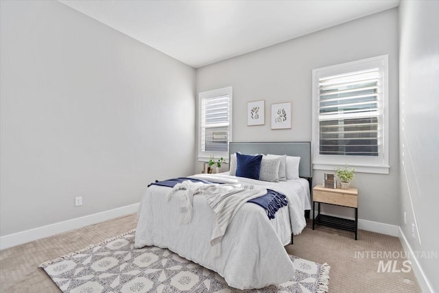 bedroom with carpet and baseboards