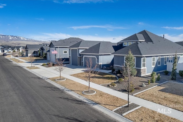 exterior space featuring a residential view, curbs, sidewalks, and a mountain view