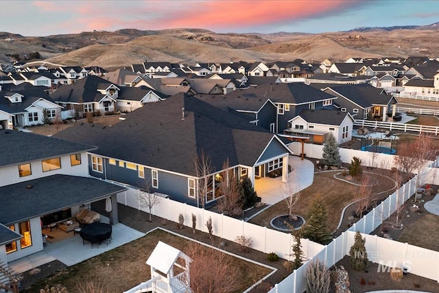 drone / aerial view featuring a residential view and a mountain view