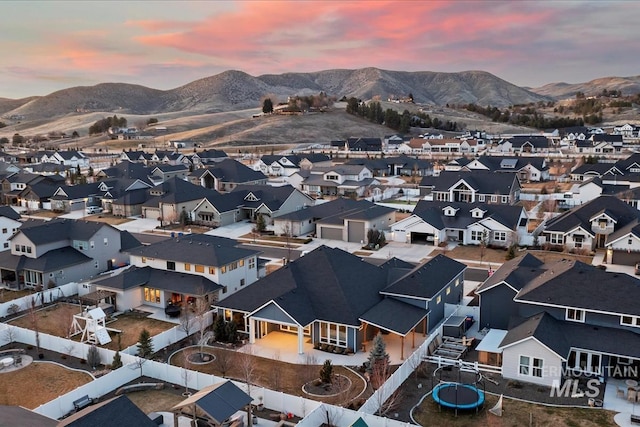 drone / aerial view featuring a residential view and a mountain view