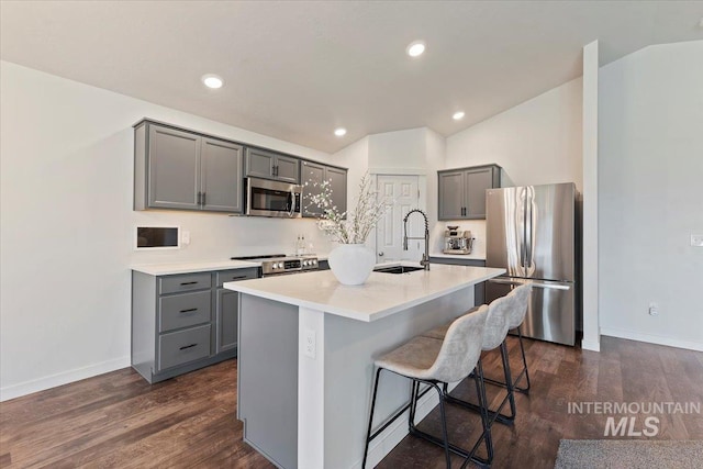19558 Delmarva Ave, Caldwell, ID 83605 - kitchen featuring stainless steel appliances, gray cabinetry, dark wood-type flooring, a breakfast bar, and recessed lighting