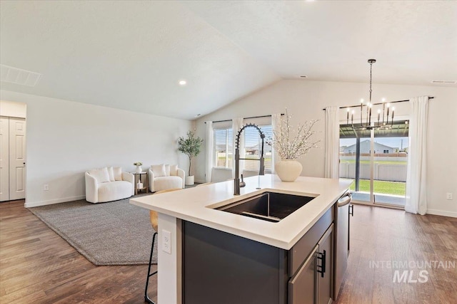 19558 Delmarva Ave, Caldwell, ID 83605 - kitchen featuring dark wood-style flooring, lofted ceiling, dishwasher, a chandelier, and light countertops