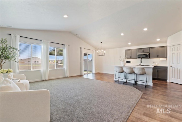 19558 Delmarva Ave, Caldwell, ID 83605 - living area featuring a chandelier, lofted ceiling, wood finished floors, and recessed lighting