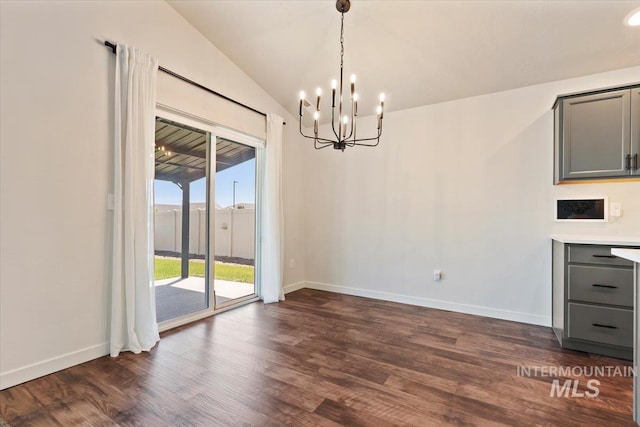 19558 Delmarva Ave, Caldwell, ID 83605 - unfurnished dining area with a chandelier, dark wood finished floors, and lofted ceiling