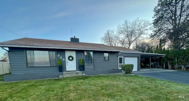 single story home with a garage, a carport, and a front yard