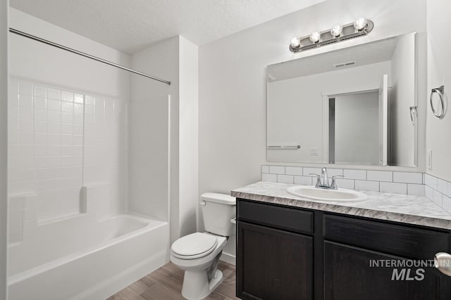 17892 Sunset Ridge Ave, Nampa, ID 83687 - bathroom featuring toilet, a textured ceiling, shower / washtub combination, wood finished floors, and vanity