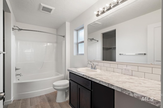 17892 Sunset Ridge Ave, Nampa, ID 83687 - bathroom with visible vents, toilet,  shower combination, and wood finished floors