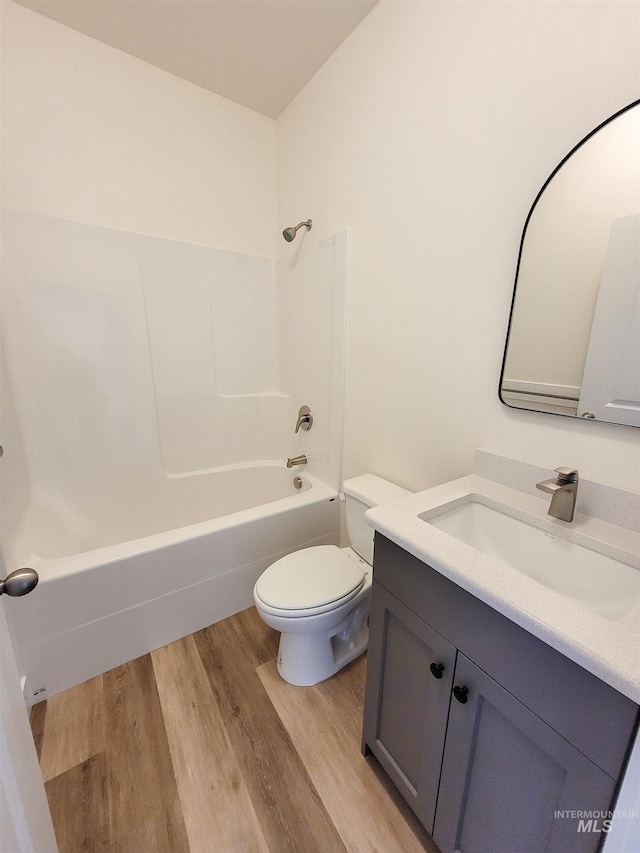 full bathroom with wood-type flooring, vanity, toilet, and shower / bathtub combination