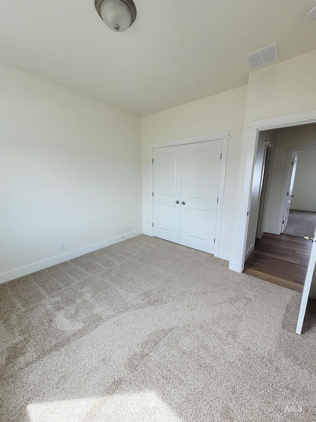 unfurnished bedroom with carpet and a closet