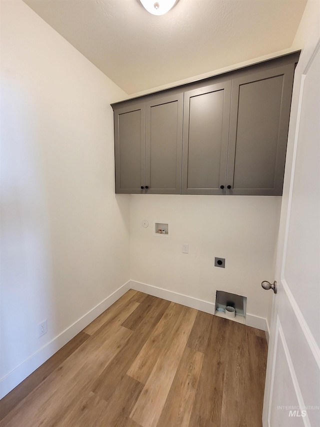 washroom with cabinets, washer hookup, electric dryer hookup, and light hardwood / wood-style flooring