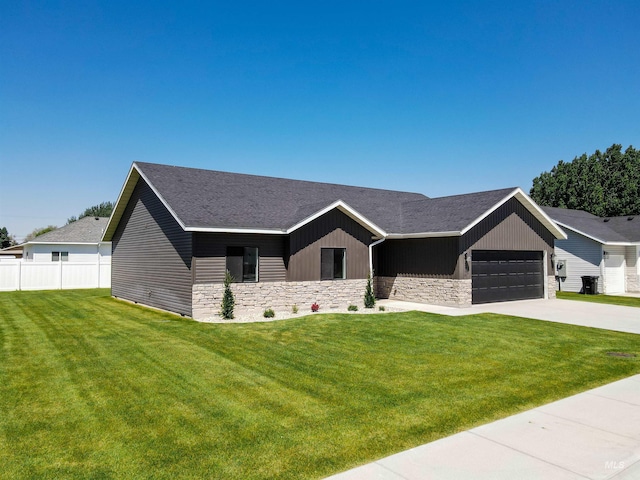 2350 Dorchester Ave, Burley, ID 83318 - view of front of home with stone siding, concrete driveway, an attached garage, and roof with shingles