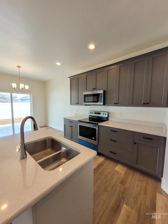 2350 Dorchester Ave, Burley, ID 83318 - kitchen featuring stainless steel appliances, a sink, wood finished floors, hanging light fixtures, and recessed lighting